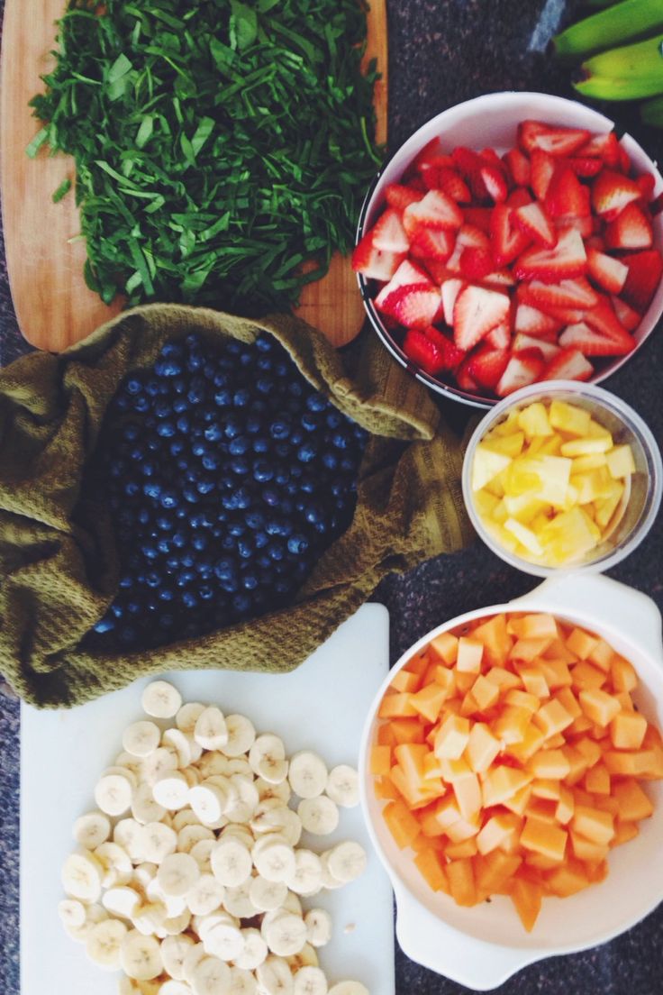 A variety of fruits and vegetables on a chopping board, perfect for a healthy meal.