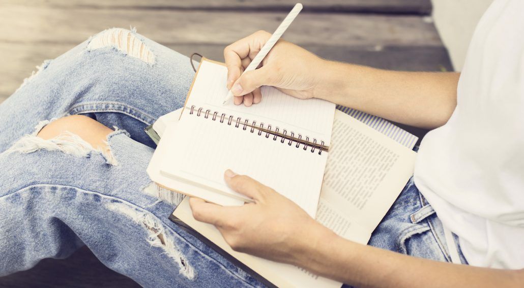 A person jotting in a notebook whilst studying Chinese medicine techniques. Mornington Chinese Medicine