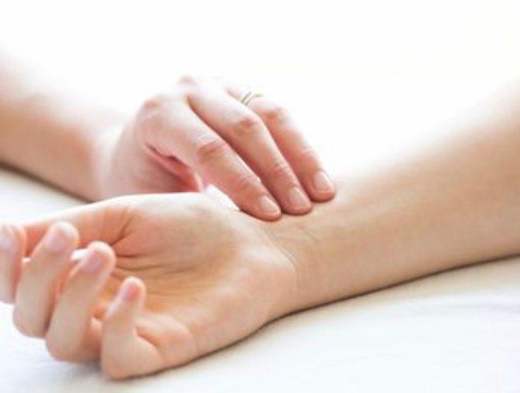 A hand on a white surface, potentially used for acupuncture in Chinese medicine. Mornington Chinese Medicine