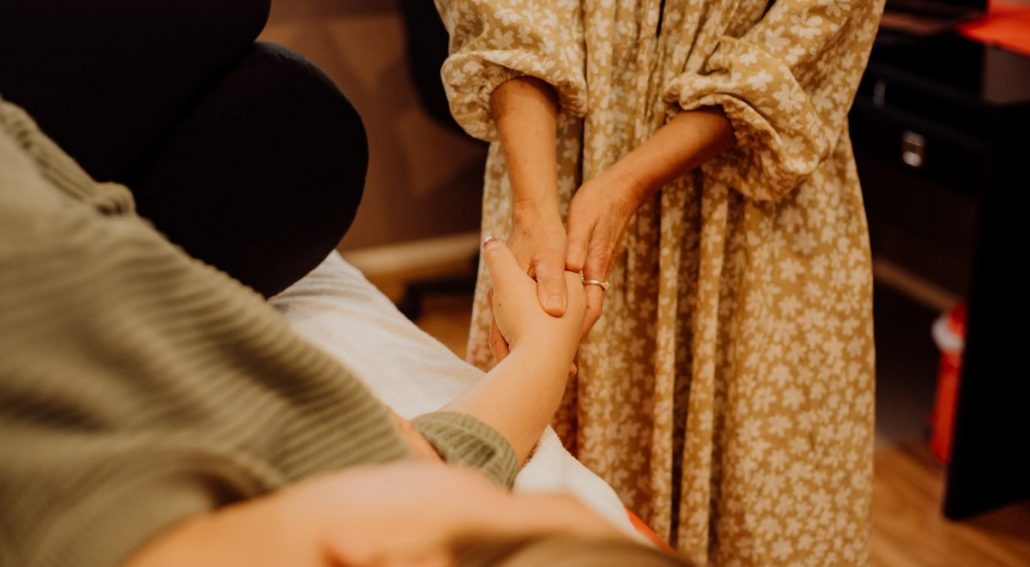 A person holding another person's hand. Mornington Chinese Medicine